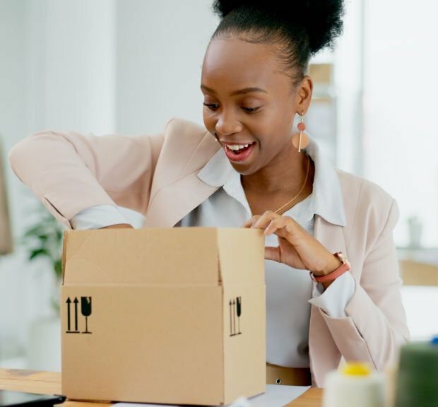 Happy black woman, box and fashion designer in supply chain, small business or inventory for boutique store. African female person smile with parcel, package or cargo for delivery or courier service